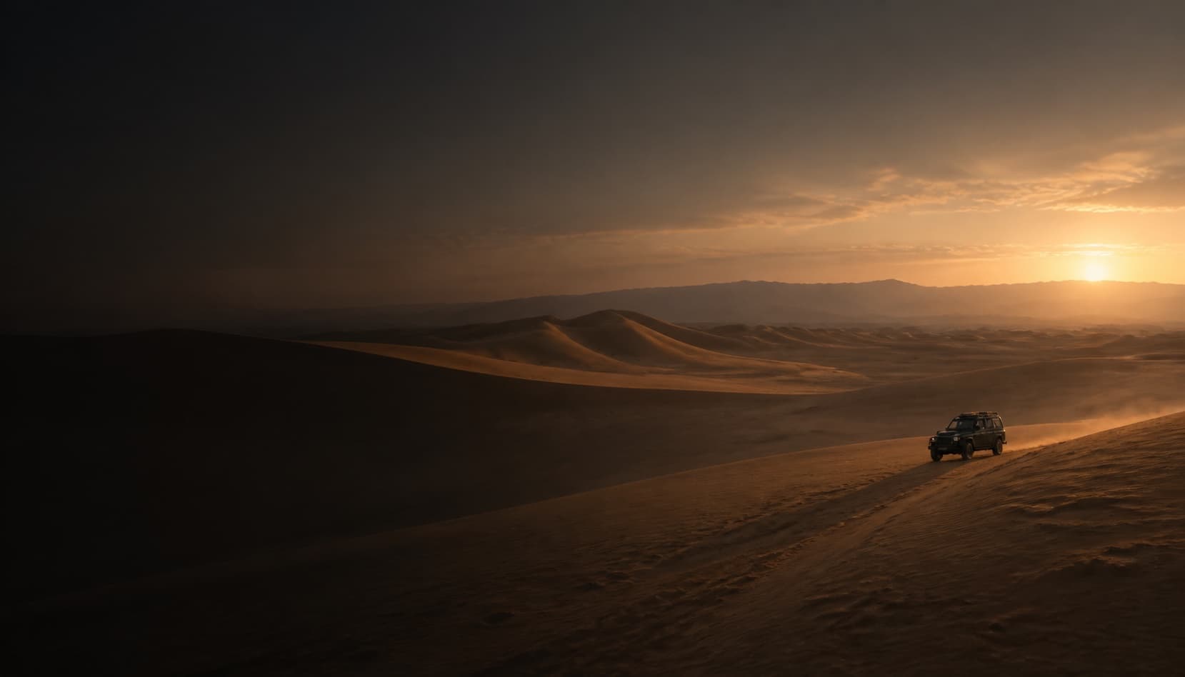 A small unbranded vehicle crosses an immense dune landscape at dusk.